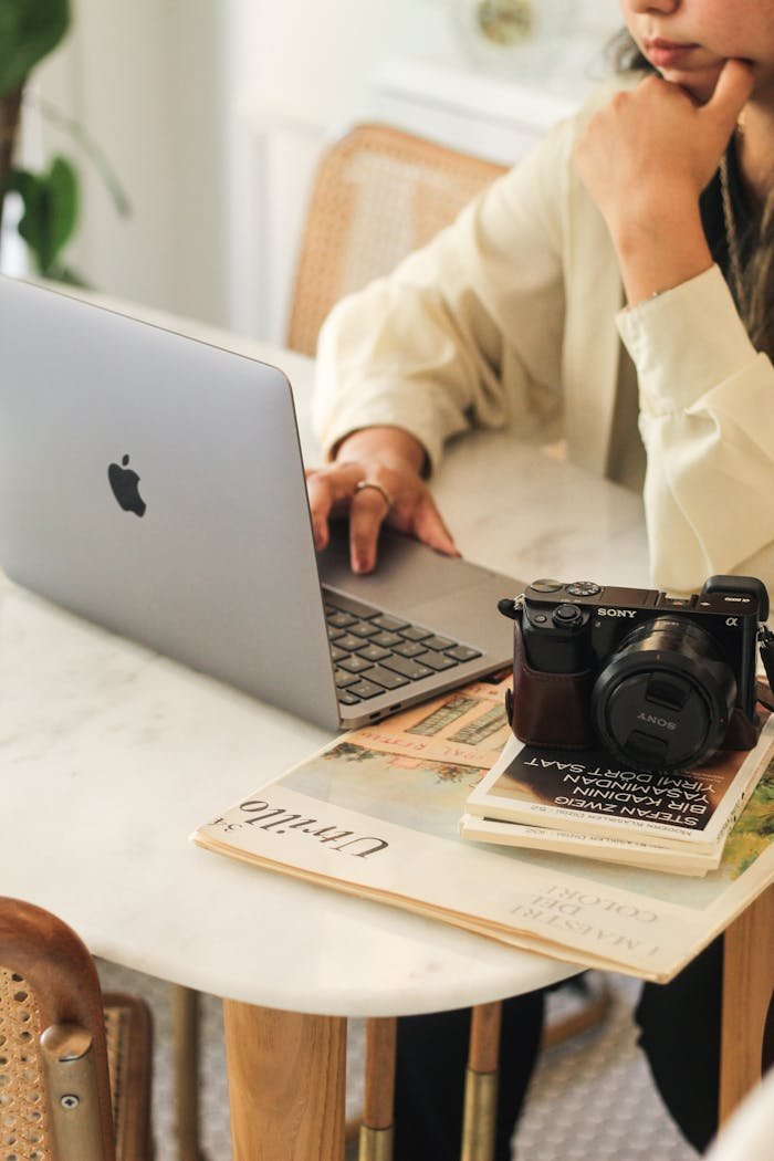 Stylish workspace featuring a laptop and camera on a desk.